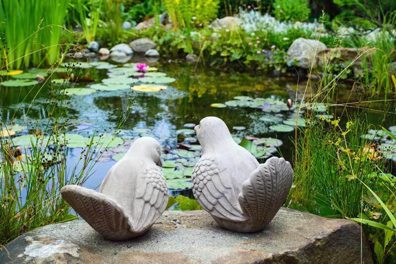 Bird sculptures by the pond