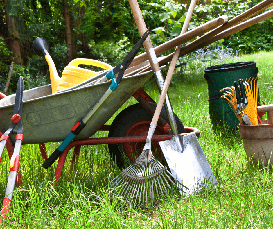 Gardening tools, rakes, water jug, and wheelbarrow